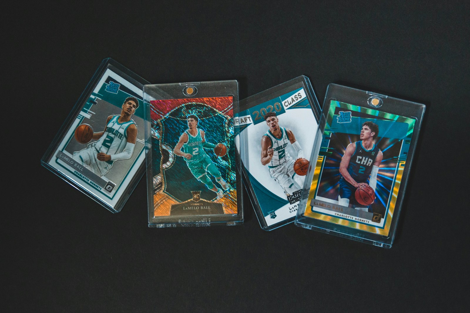 Three basketball cards on a table