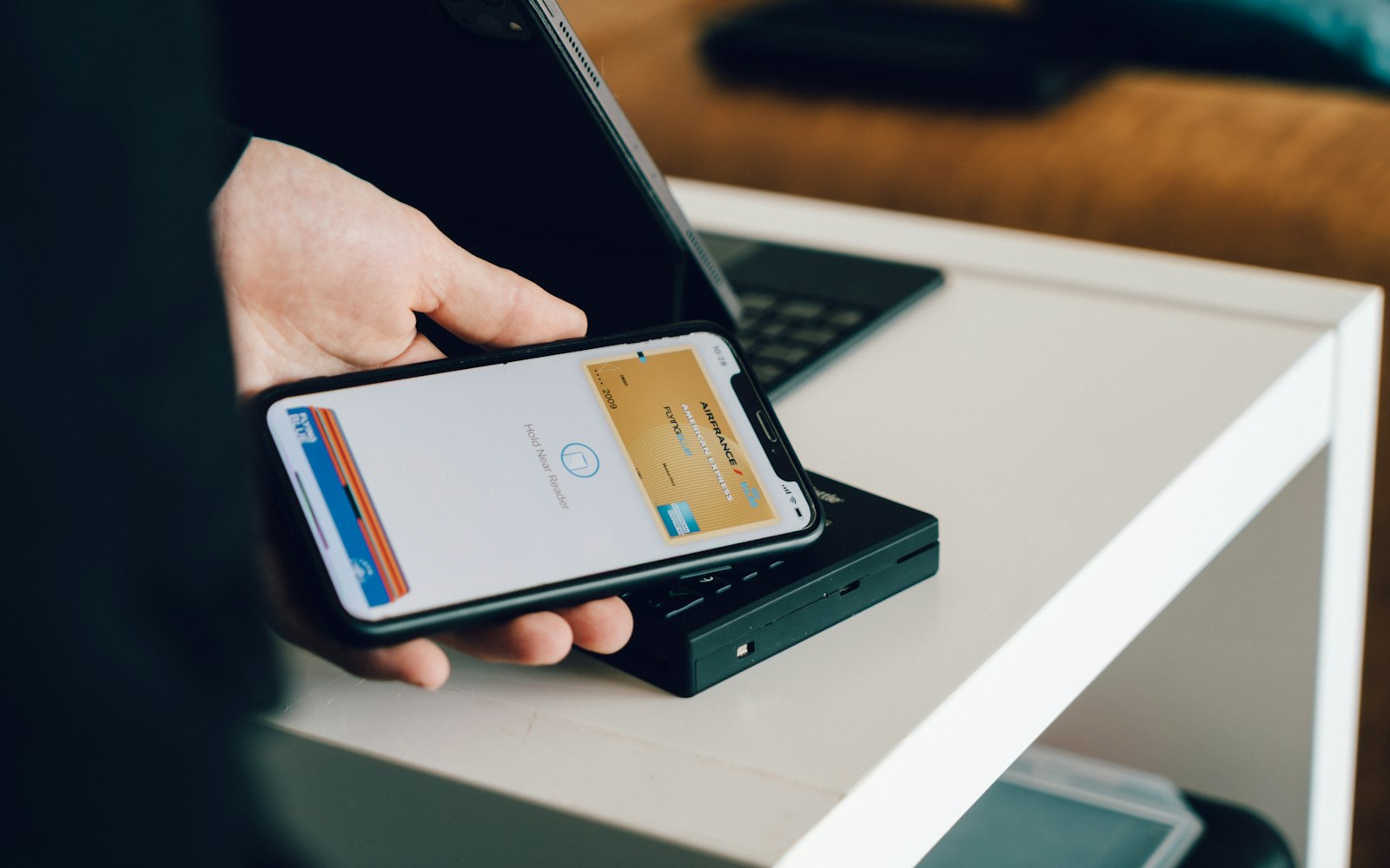 Person paying with a smartphone at a card reader